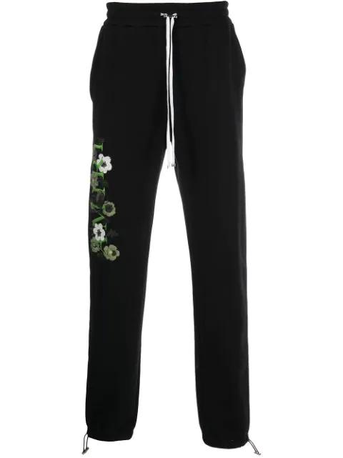 embroidered track pants by AMIRI